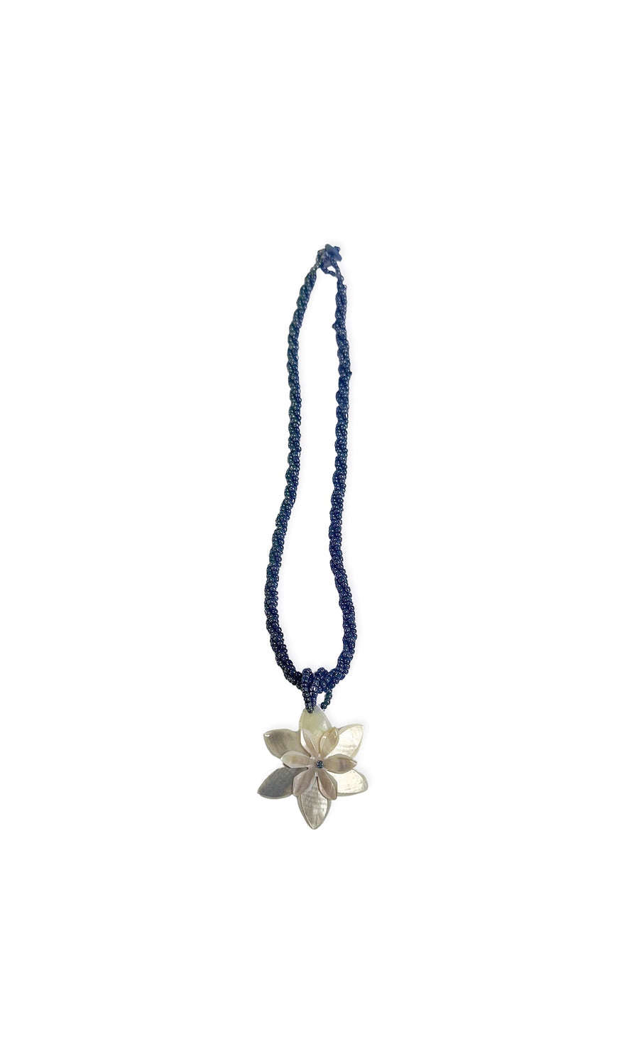 Plümo- The Valeria Necklace is a beaded dark blue piece with a shell flower pendant, shown on a white background.
