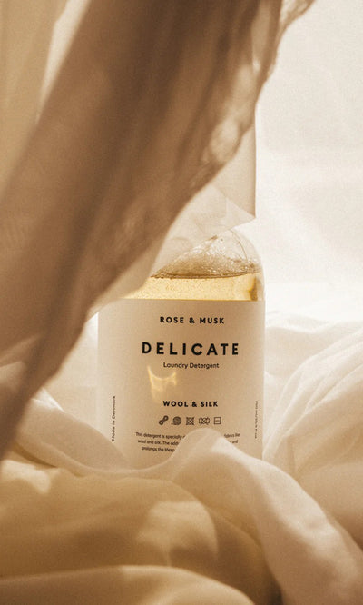Plümo  Delicate Laundry Liquid 750ml rests among soft, light-colored, and delicate fabrics.