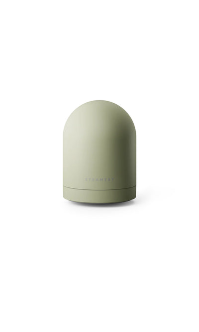 Plümo  Light green, dome-shaped Fabric Groomer with flat base and minimalist style, shown on white background.